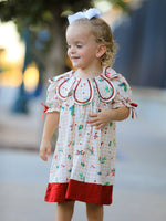Girls dress in gingham print with a ruffle collar and small bow accents at the front