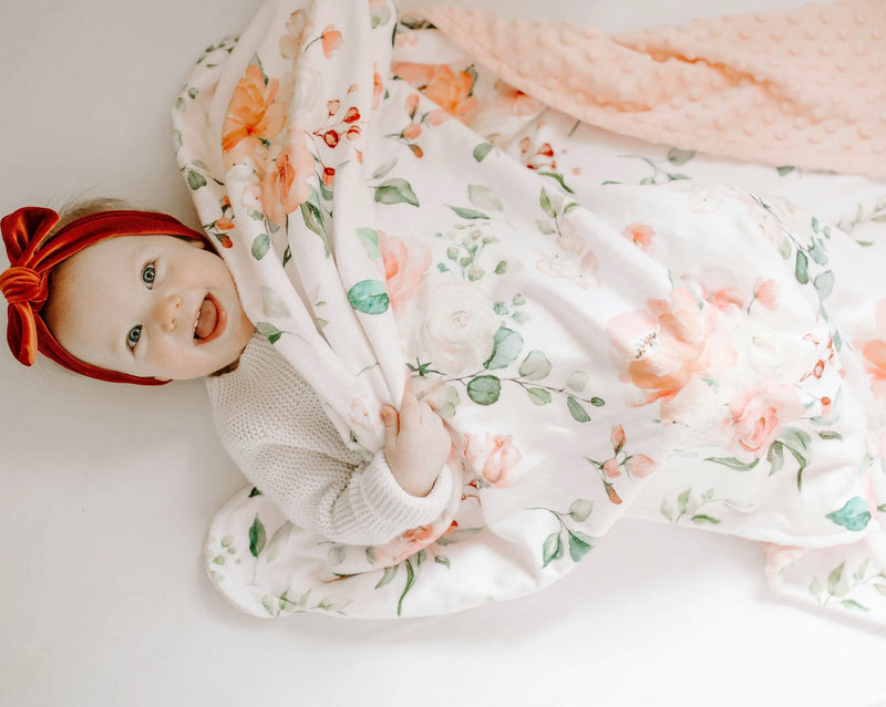 Premium baby and toddler blanket in peach floral pattern, featuring soft and lightweight fabric, ideal for delicate skin.