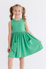 Kelly green sleeveless twirl dress with side pockets and a full skirt