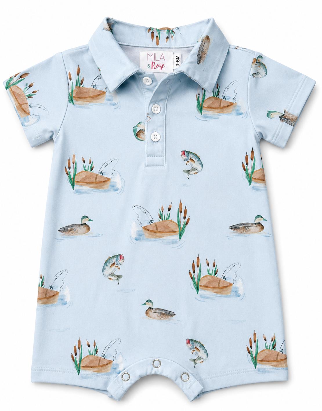 Polo-collared shorty one-piece with short sleeves in a lake day print and snap closure at the bottom