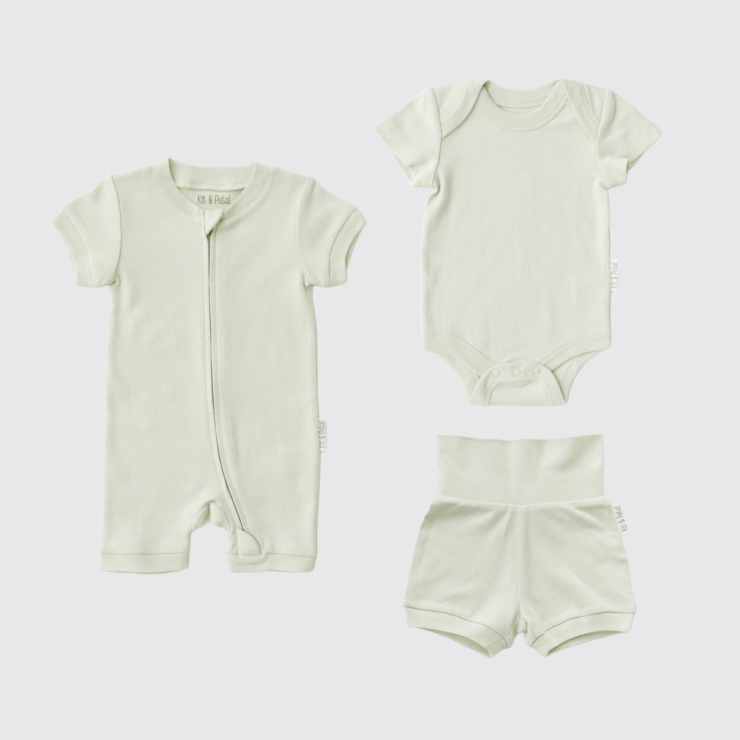 Three-piece baby outfit set in leafy green: short sleeve romper, bodysuit, and fold-over shorts