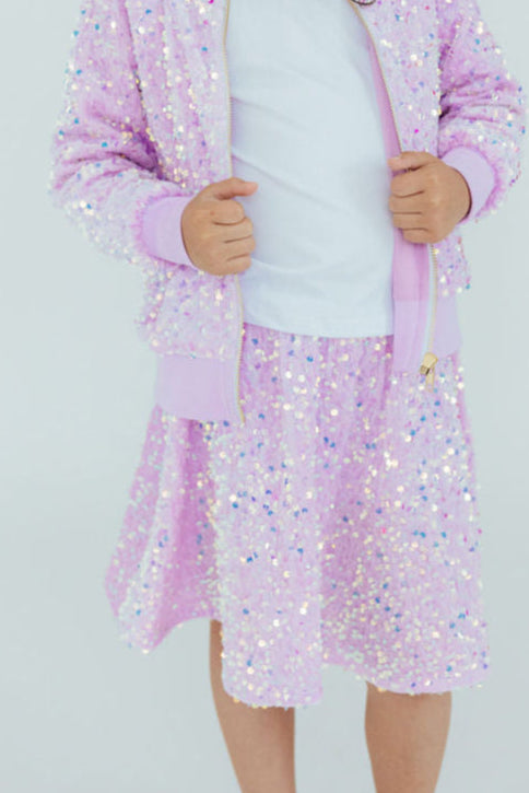 Lilac velvet sequin twirl skort with sparkly sequins and built-in shorts worn by a young girl