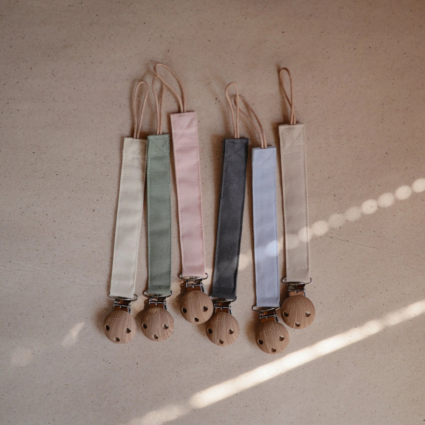 Linen Pacifier Clip Two Pack with Water Resistant Coating and Faux Wood Silicone Clasp Mushie