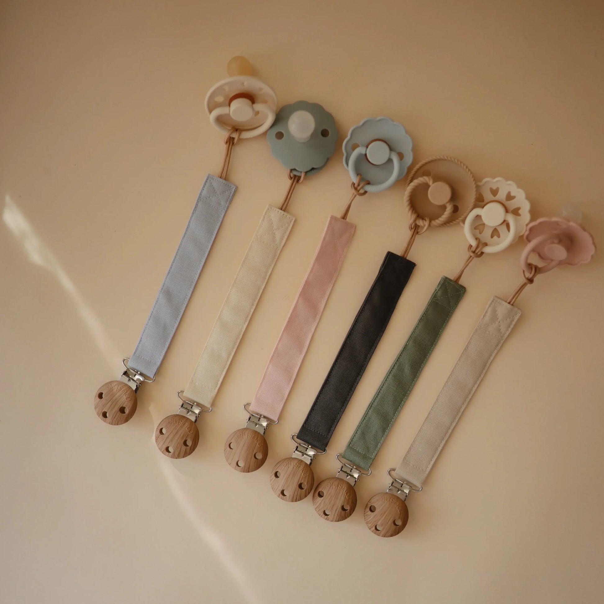 Linen Pacifier Clip Two Pack with Water Resistant Coating and Faux Wood Silicone Clasp Mushie