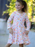 Girls long sleeve twirl dress in pink with an allover pink and orange pumpkin print