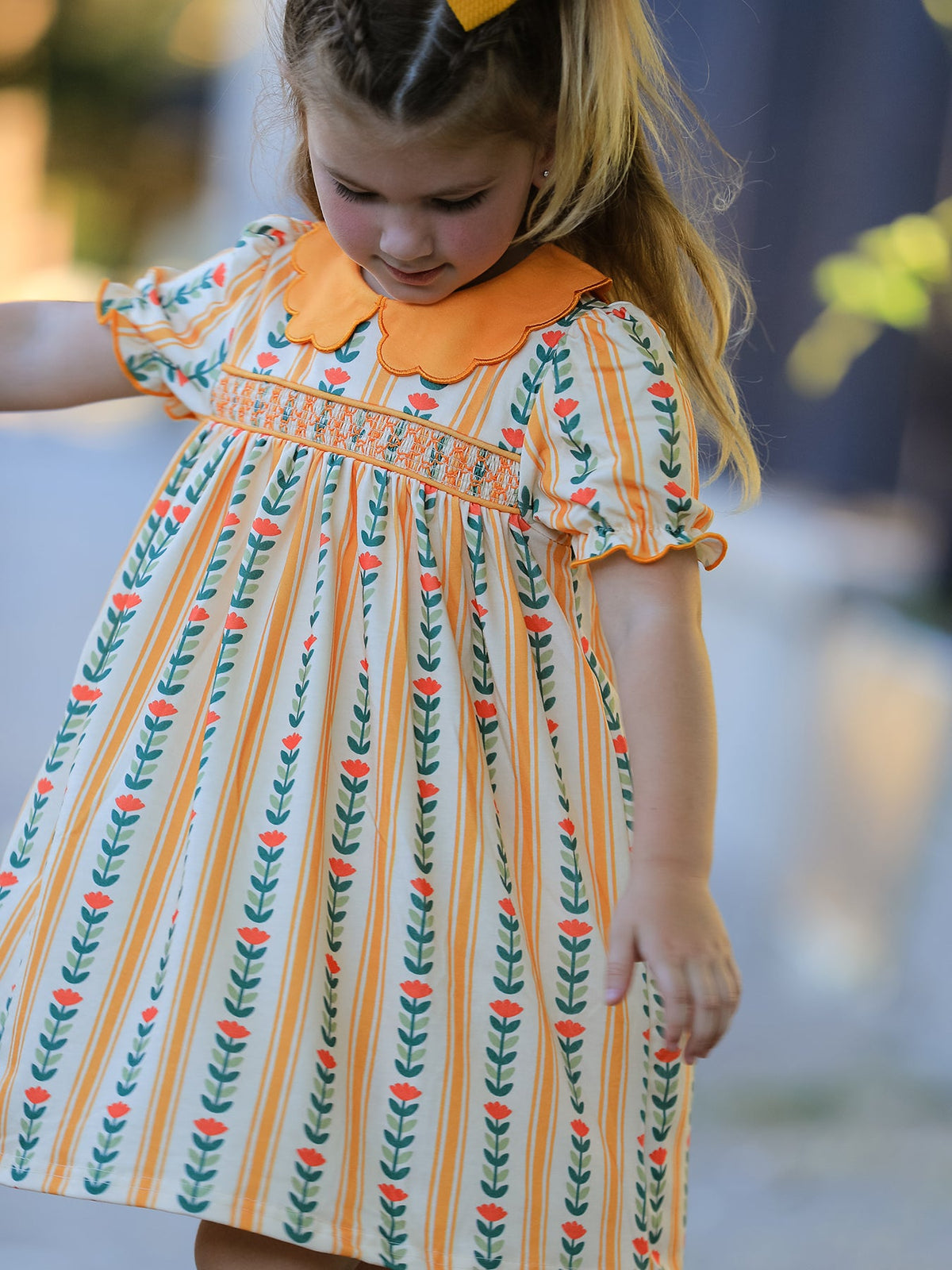 Girls dress in floral stripe print with a petals collar and smocked bodice detailing