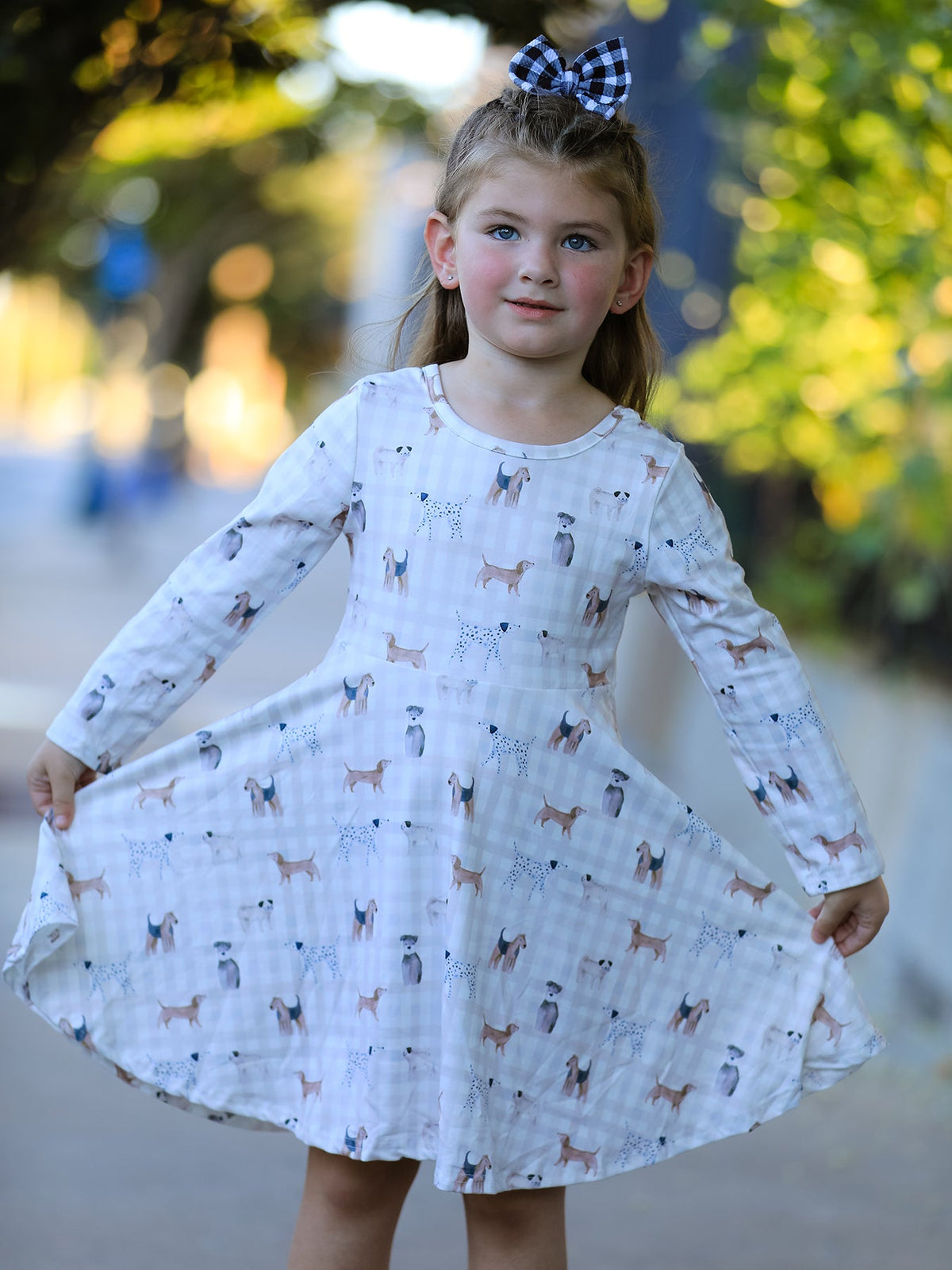 Long sleeve girls twirl dress in a plaid pattern with a dog print and full flowing skirt