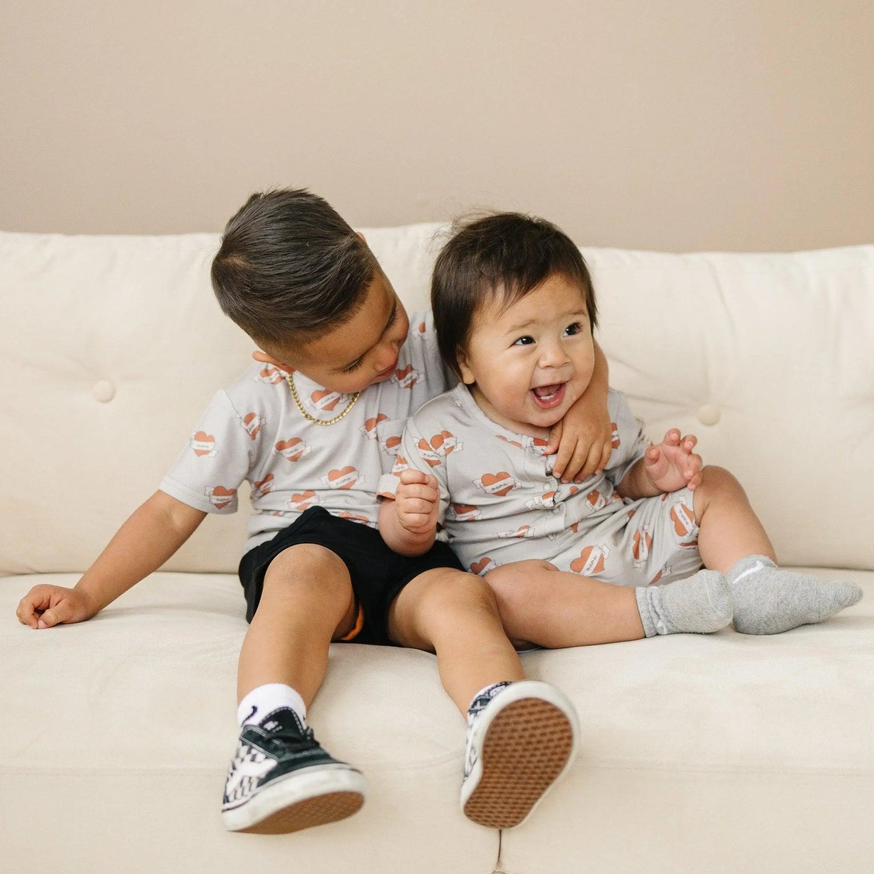 Little Joy Co. Mama Tattoo Hearts Bamboo Henley Romper for Babies - Apparel & Accessories > Clothing > Baby & Toddler Clothing > Baby One-Pieces
