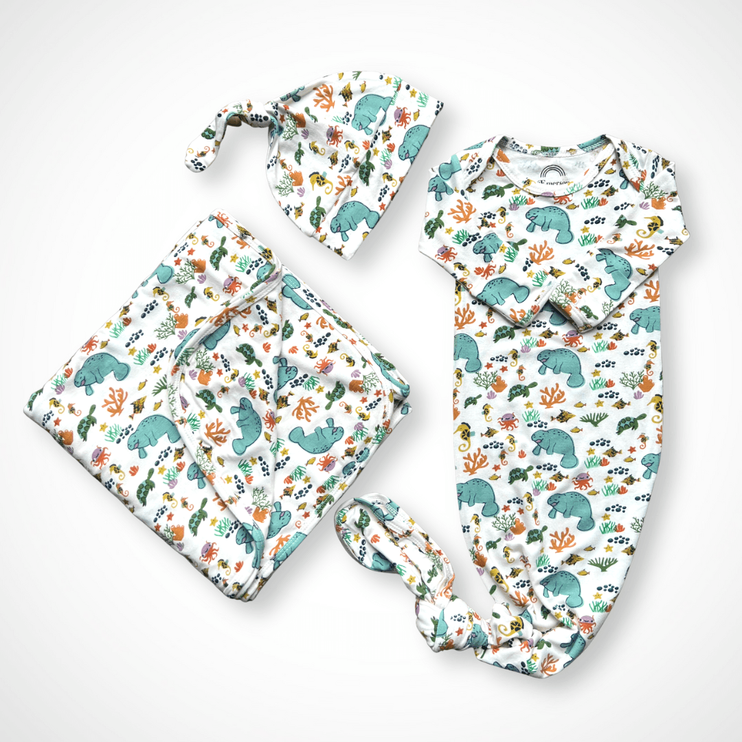 Newborn knotted gown, matching hat, and swaddle blanket in gray manatee print with gift box