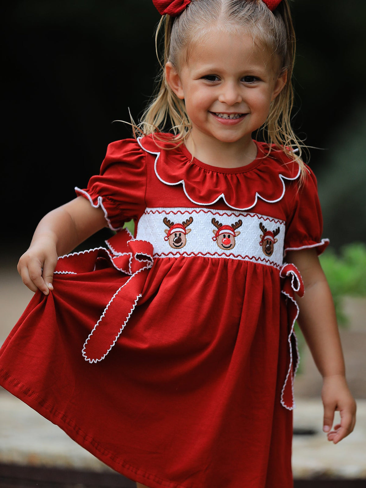 Red girls Christmas dress with embroidered reindeer on smocked chest, white-piped scalloped collar, puff sleeves and side
