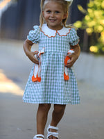 Plaid girls dress with white Peter Pan collar, puff sleeves, smocked waist and oversized bows with pumpkin appliques