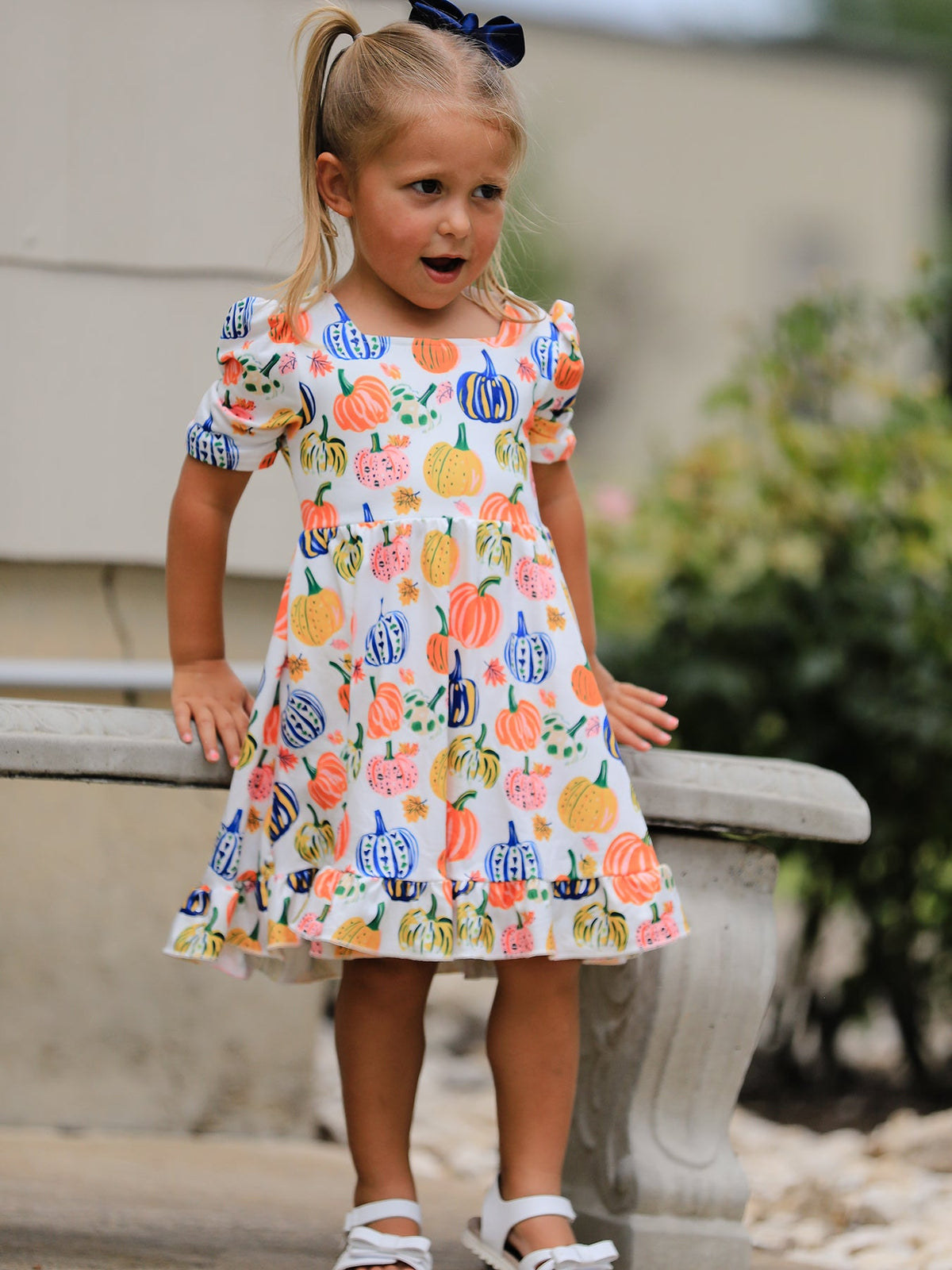 Girls pumpkin print dress with square neckline and ruffle hem