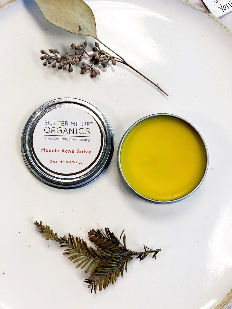 Organic Muscle Ache Salve in a tin with herbal ingredients, zero waste, plastic-free.