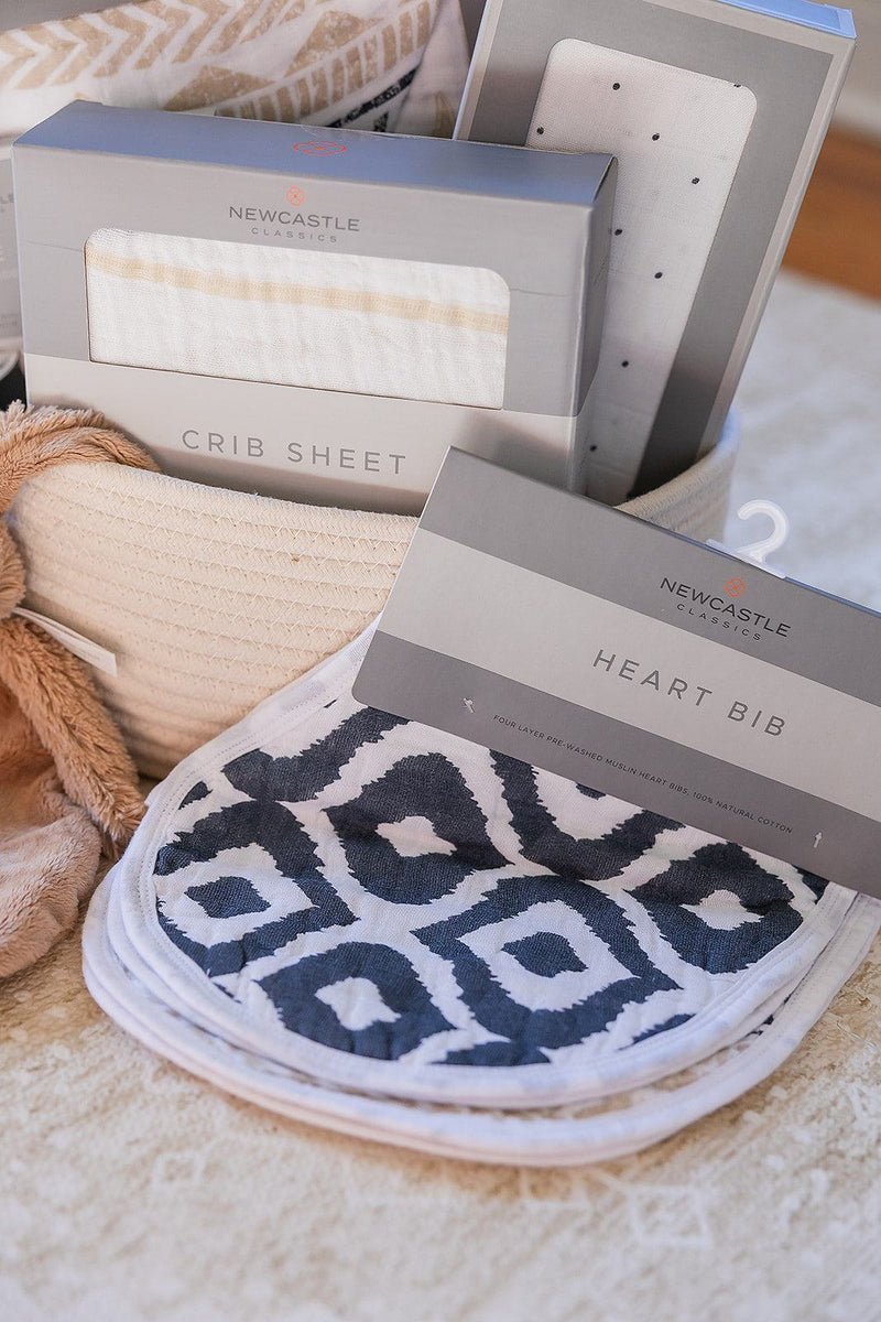 Welcome Baby basket with crib sheet, bib, swaddle, and Rabbit Richie toy in a cotton rope basket.