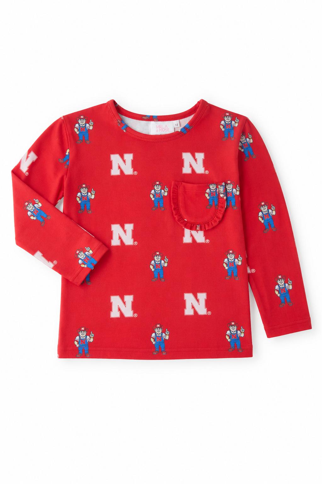 Red long-sleeve ruffle pocket tee with Nebraska Herbie Husker design for girls.