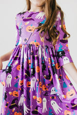 Twirl dress with 3/4 sleeves, a front pocket and "No Tricks, Just Treats" Halloween print