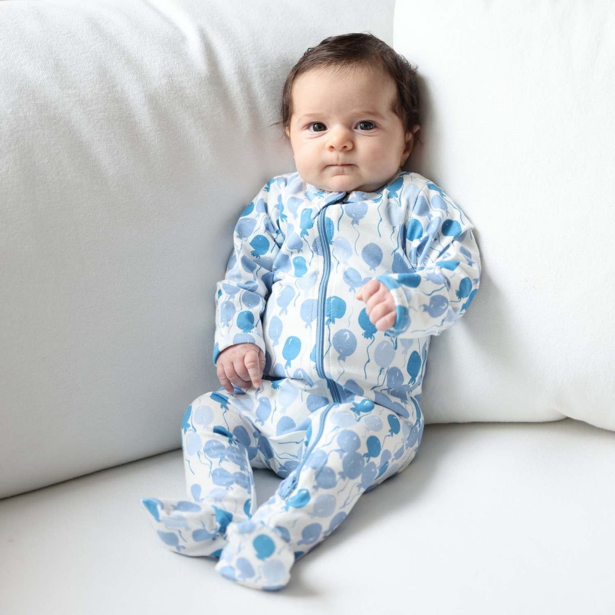 Norani Baby organic footie sleeper with blue balloons design.