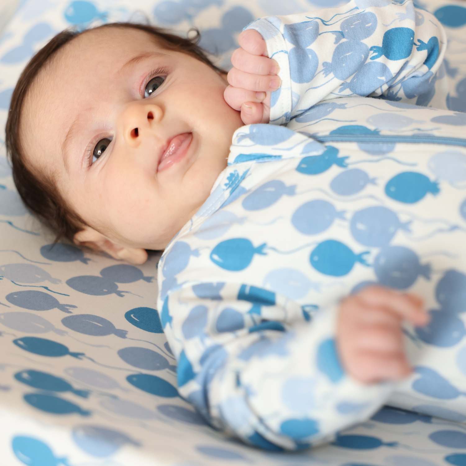 Norani Baby organic footie pajamas with blue balloon print.