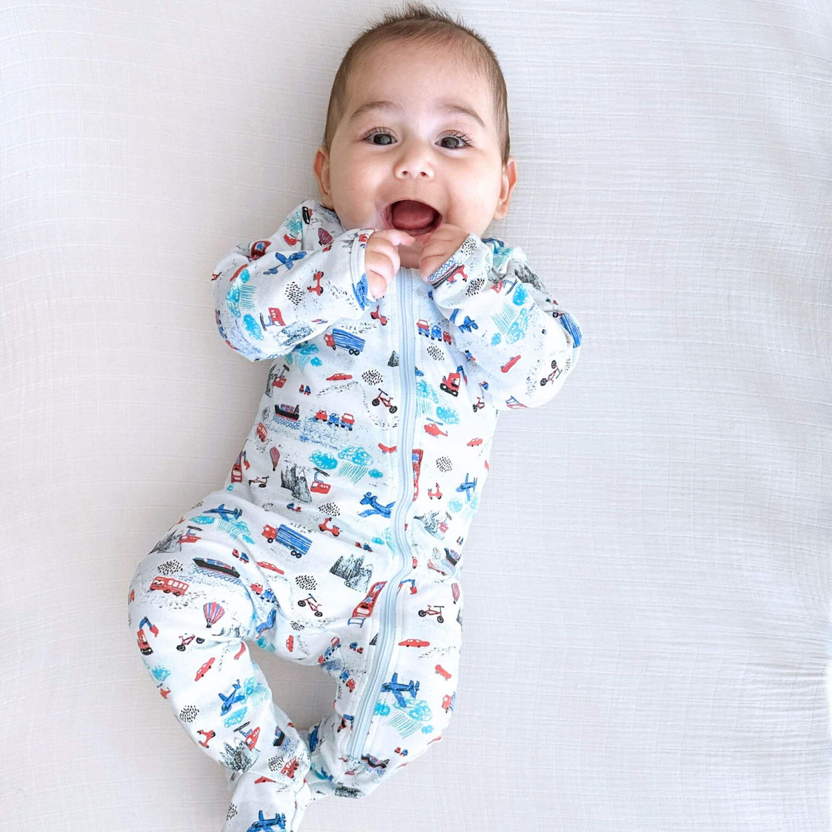 Norani Baby organic footed onesie for newborns with contrast zipper.