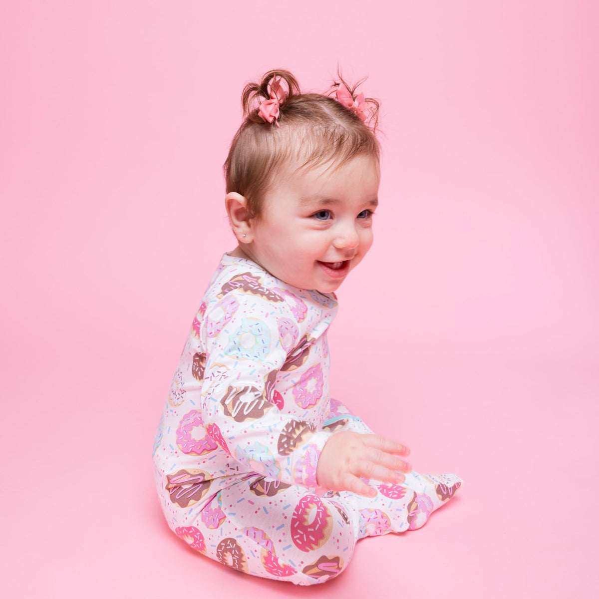 Norani Baby organic footie pajamas with colorful donut print.