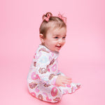 Norani Baby organic footie pajamas with colorful donut print.