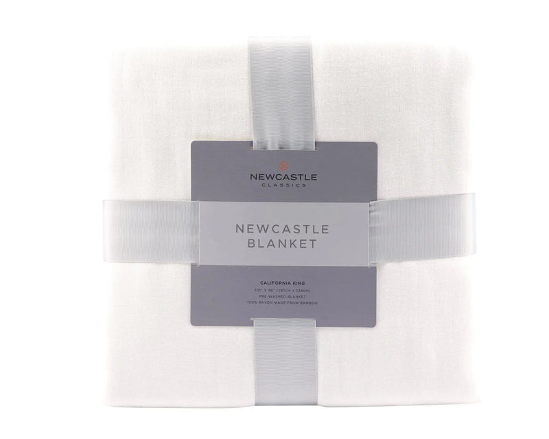 Pristine White Oversized King Bamboo Muslin Bed Blanket in packaging.