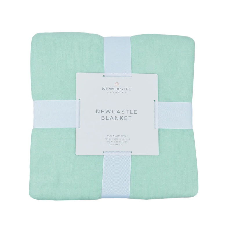 Seafoam green oversized king luxury bamboo bed blanket in packaging.