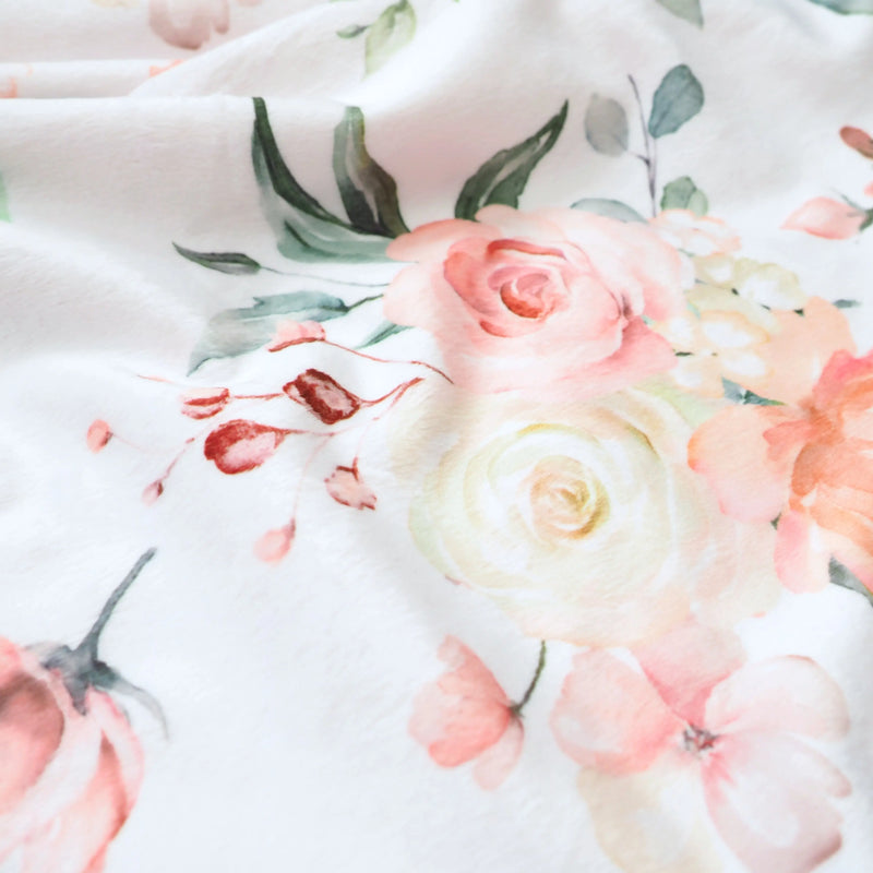Premium baby and toddler blanket with peach floral pattern, super soft and lightweight, featuring minky dot texture for sensory stimulation.