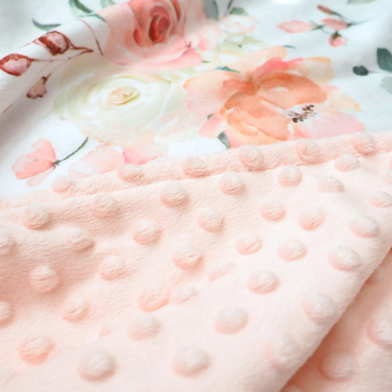 Premium peach floral baby and toddler blanket with soft minky dot texture.