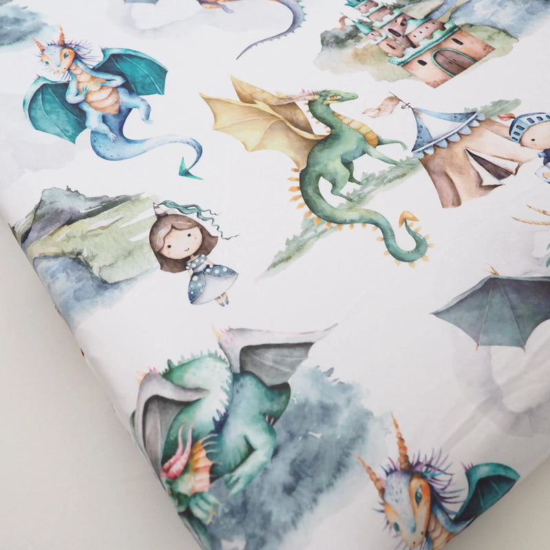 Dragons and knights themed changing pad cover with soft fabric and vibrant design.