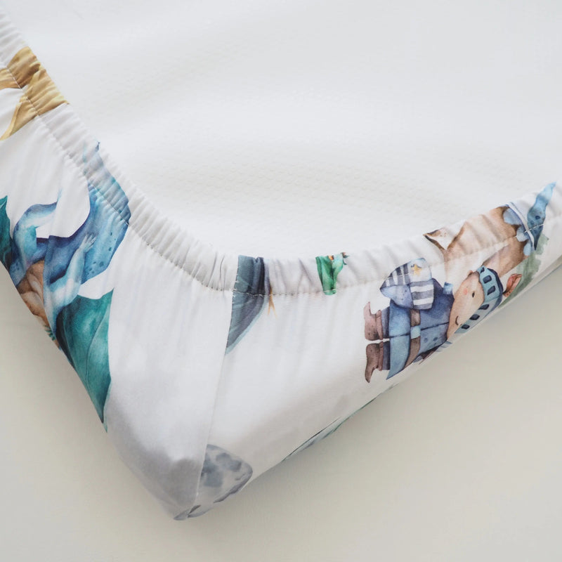 Changing pad cover with dragons and knights design, soft and stretchy fabric.