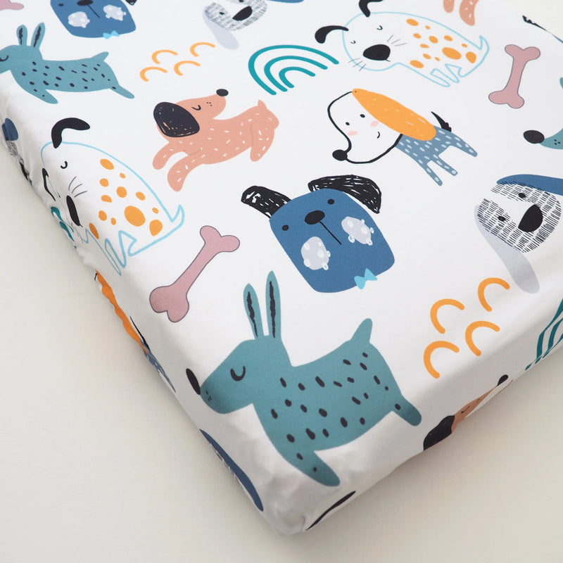 Changing pad cover with playful dog pattern, soft and stretchy fabric.