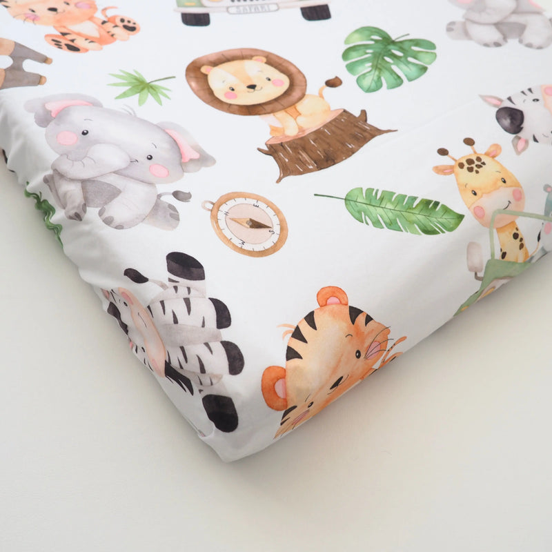 Safari-themed changing pad cover with soft, stretchy fabric featuring animals and greenery.
