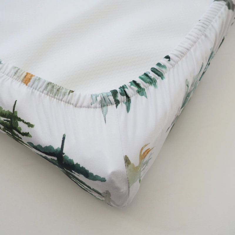 Soft and stretchy "In The Woods" changing pad cover with forest print for baby nursery.