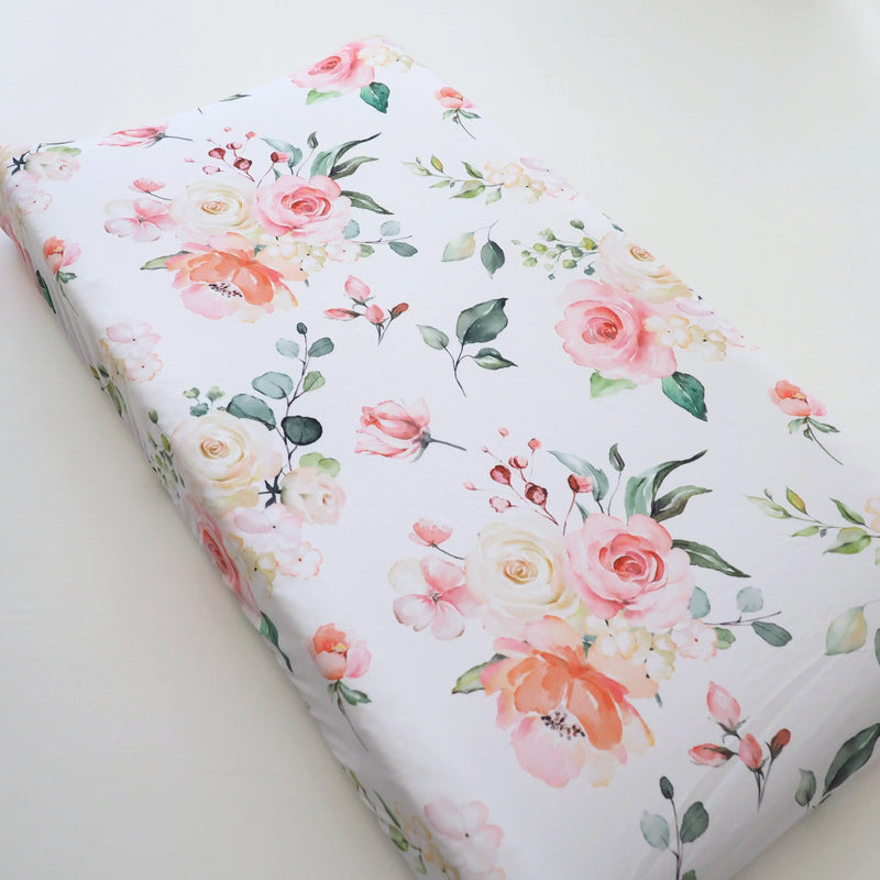 Peach floral changing pad cover, soft and stretchy fabric, 32x16 inches.
