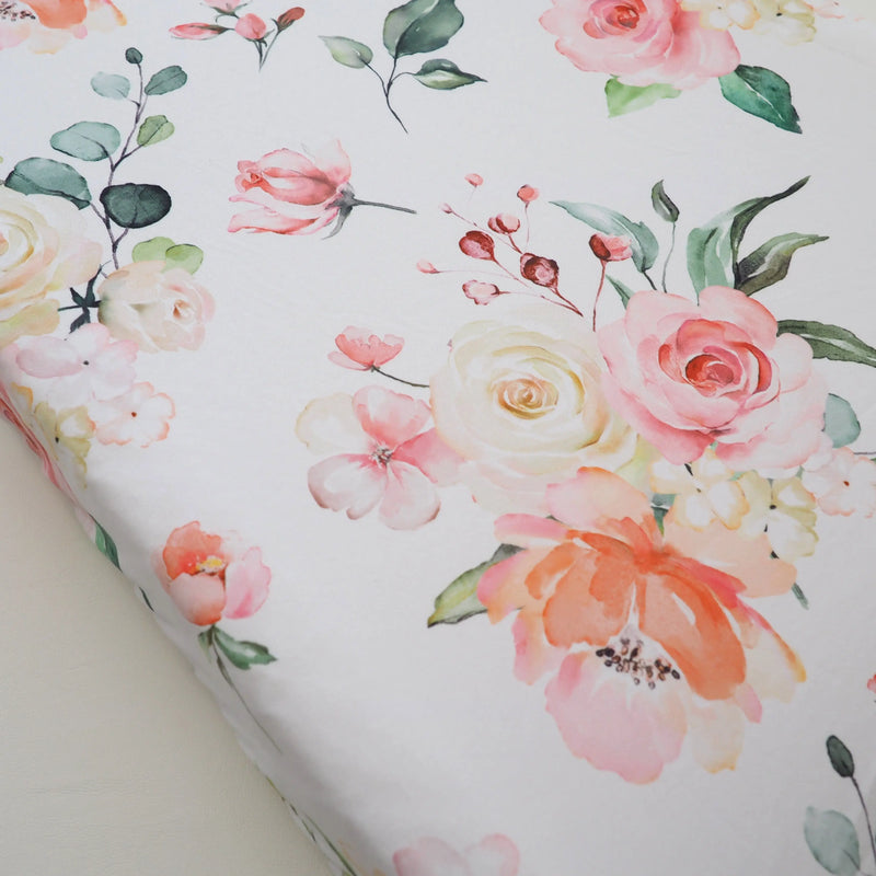 Peach floral changing pad cover, soft and stretchy fabric.