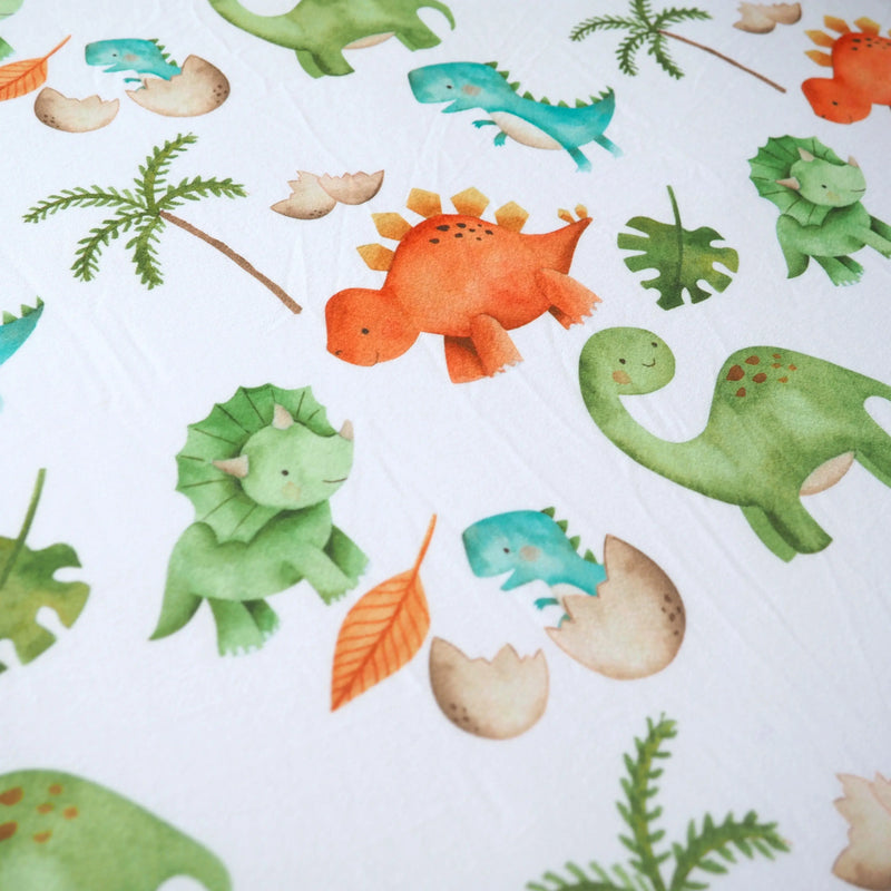 Dinosaur patterned fitted crib sheet.