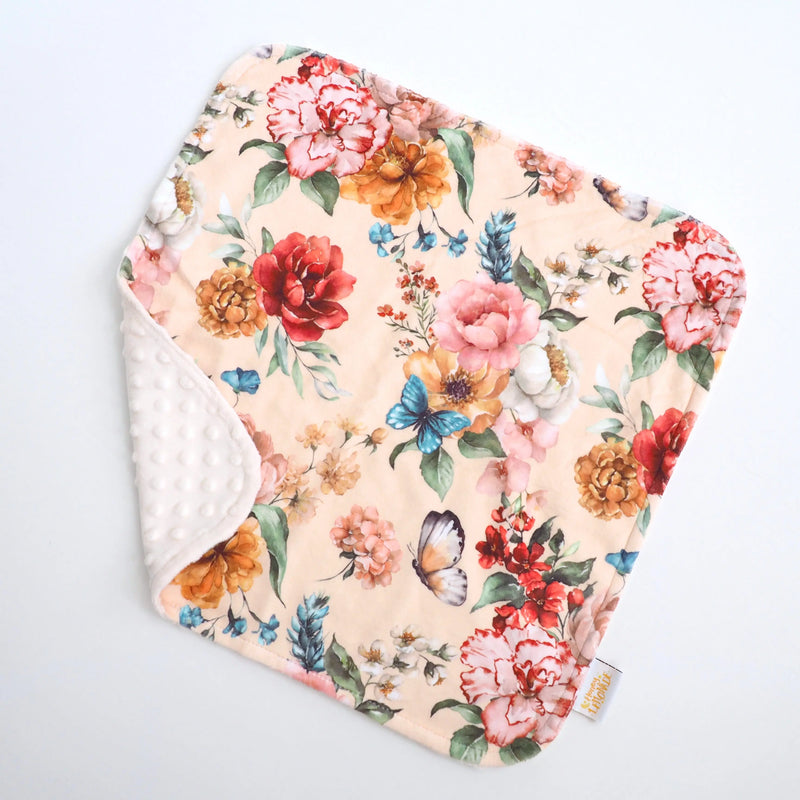 Colorful floral toddler blanket with soft Minky dot texture.