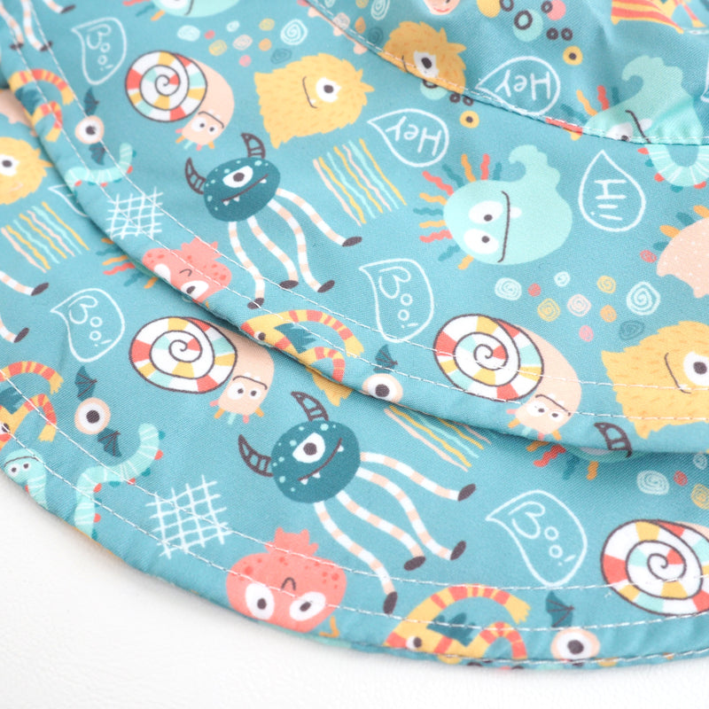 Baby and kid sun hat with whimsical monster party design.