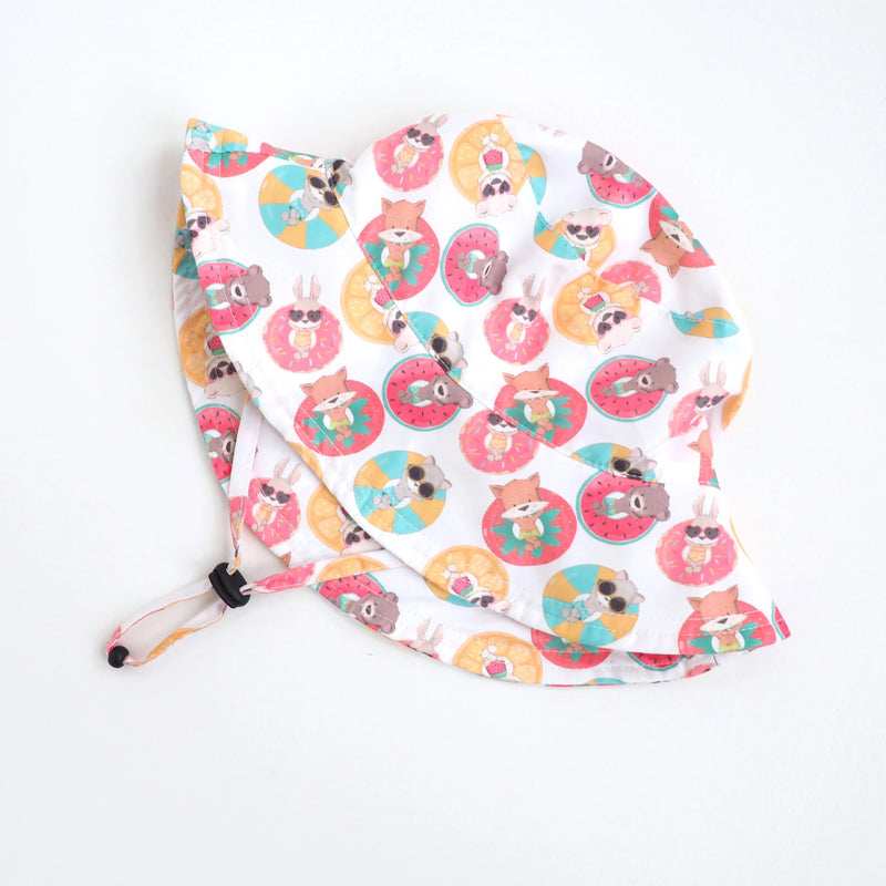 Colorful baby and kids sun hat with playful animal and float print, featuring adjustable strap for beach outings.