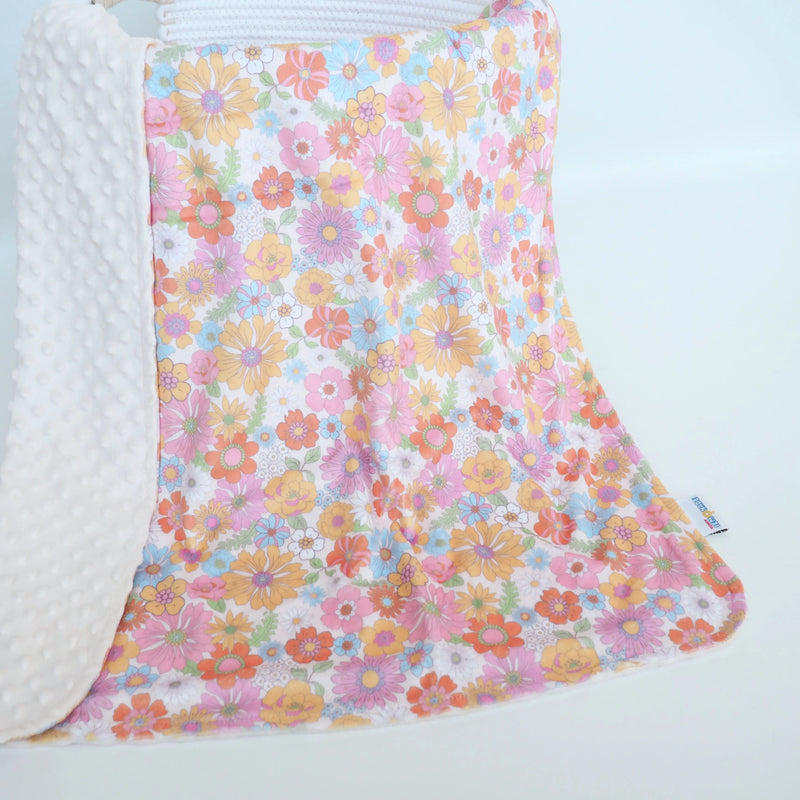 Baby and toddler minky blanket with retro floral design, soft and sensory-friendly.