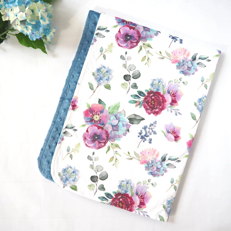 Premium blue floral minky baby blanket with soft texture, larger size, and sensory-stimulating dots.