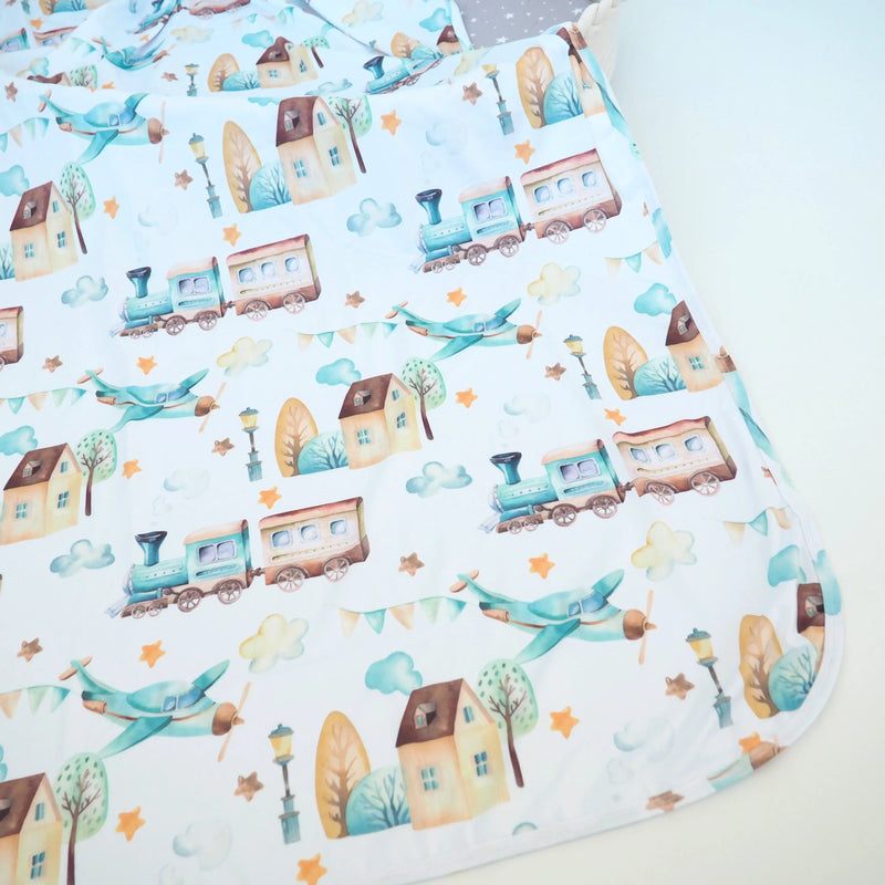 buttery soft and stretchy swaddle blanket with airplane and train pattern