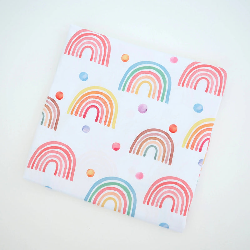Buttery soft and stretchy swaddle blanket with rainbow design.