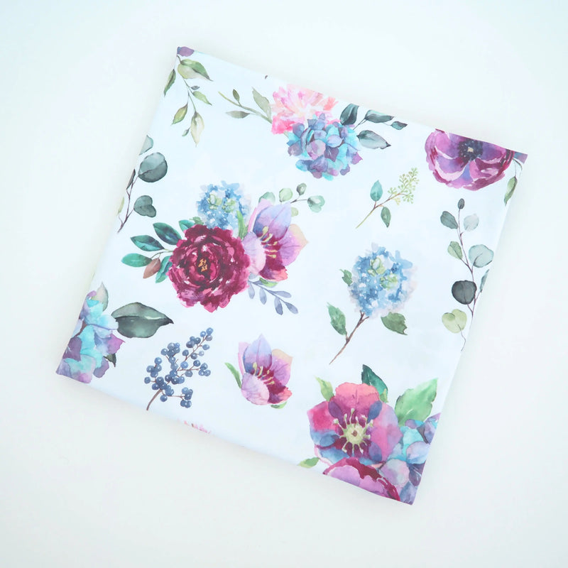 Buttery soft and stretchy blue floral swaddle blanket in rayon and spandex blend.