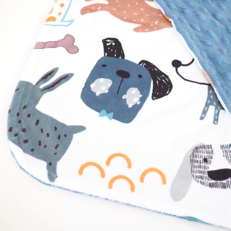 Mini Minky toddler blanket with dog print and blue dot texture.
