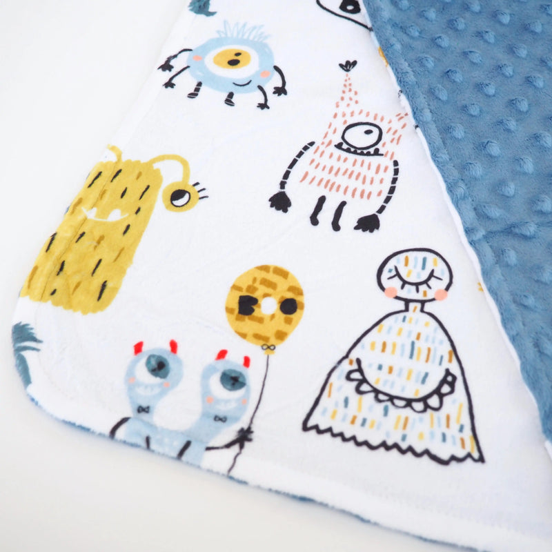 Mini Minky toddler blanket with colorful monster friends design on soft Minky fabric.