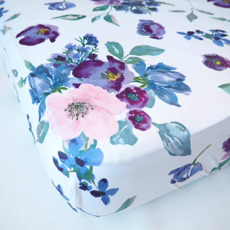 Purple and blush floral fitted crib sheet with soft fabric.