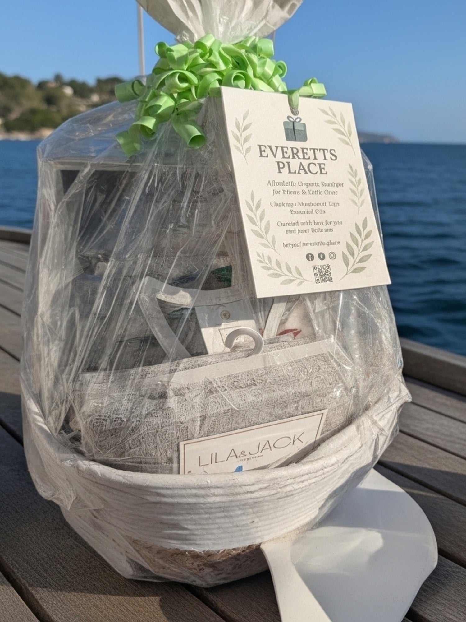 Gift wrapped with a visible 'Everetts Place' tag on a wooden surface by the water.