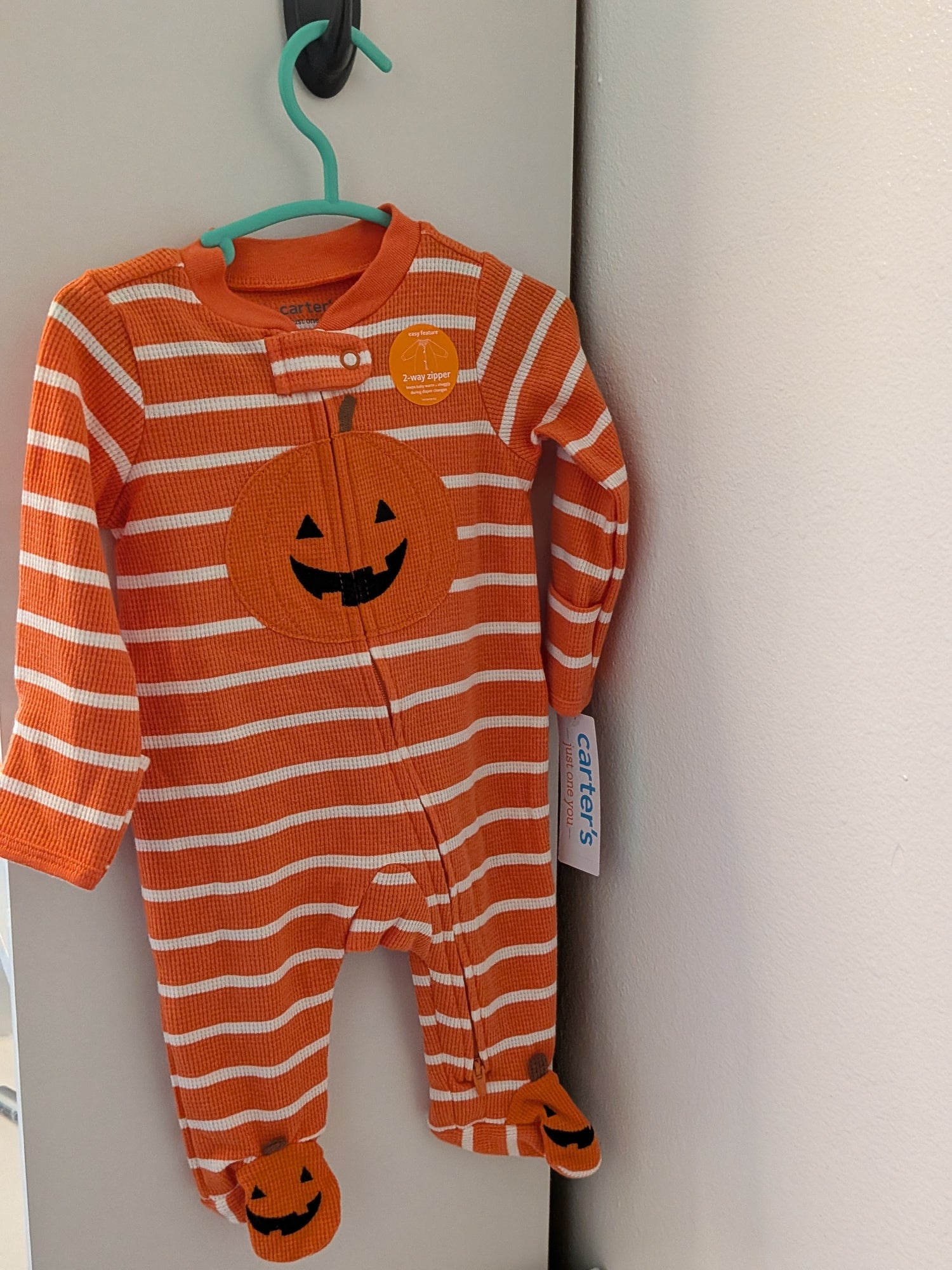 Baby footed sleeper in a pumpkin theme